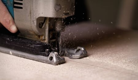 Photo of a man working with fret saw