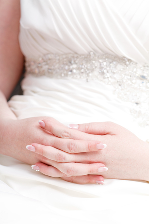 Close up photo of the bride hand in her dressの写真素材