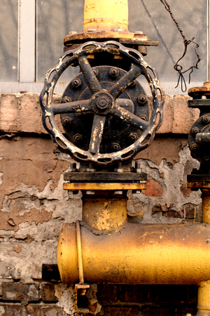 Closeup shot of big rusted valve industrial siteの写真素材