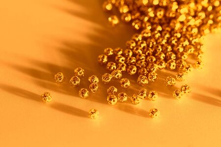 Beautiful golden metal beads closeup on white backgroundの写真素材