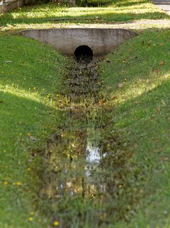 Ditch through with water in the villageの写真素材