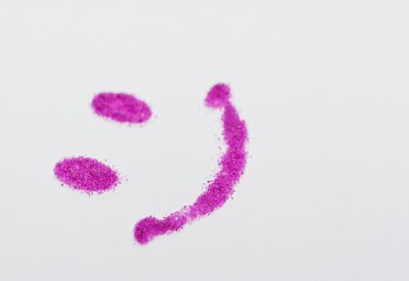 Pink smile of sand on white background - macro photoの写真素材