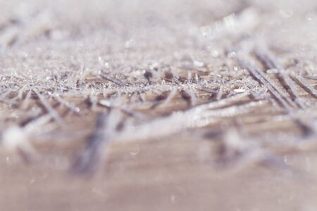 Morning frost on a wooden table - macro picture