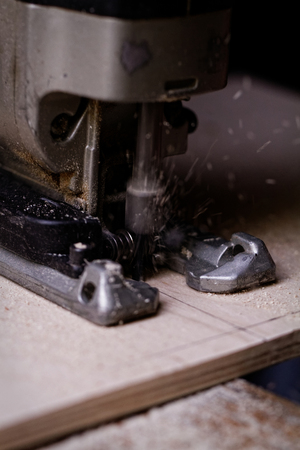 Photo of a man working with fret sawの写真素材