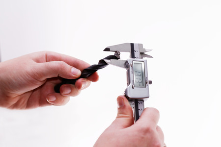 Digital Caliper in a man hand isolated on white backgroundの写真素材