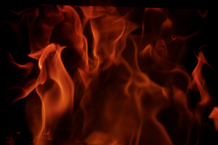 Fire flames with reflection on black backgroundの写真素材