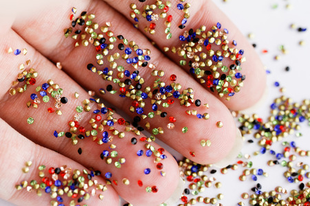 Small rhinestone in one hand -  macro photoの写真素材