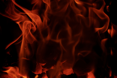Fire flames with reflection on black backgroundの写真素材