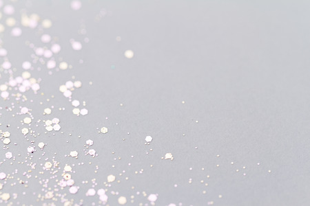 Color glitter on light background - macro photo