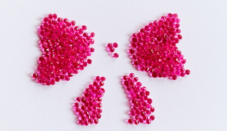 Pink bow of crystal beads on white backgroundの写真素材