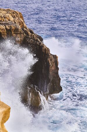 Huge waves crash on cloudy day. Kemmuna islandの写真素材