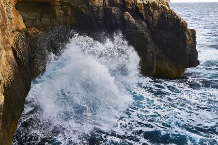 Huge waves crash on cloudy day. Kemmuna islandの写真素材