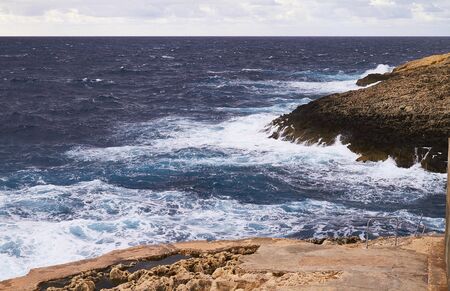 Huge waves crash on cloudy day. Kemmuna islandの写真素材