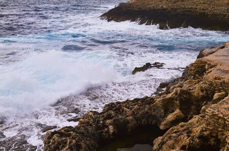 Huge waves crash on cloudy day. Kemmuna islandの写真素材