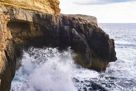 Huge waves crash on cloudy day. Greece -Kemmuna islandの写真素材