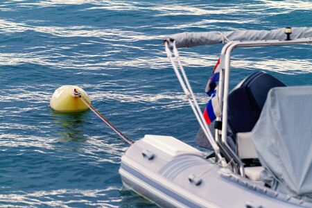 White motorboat with yellow buoy - detail photoの写真素材