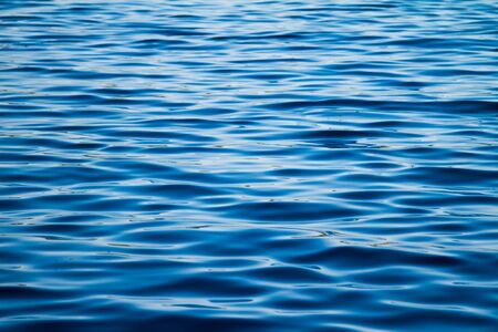 Calm blue water ripples on a windless dayの写真素材