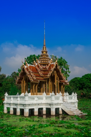 thai style pagoda in middle of poolの写真素材