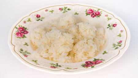 thai jasmine cooked rice on plate with isolated on whiteの写真素材