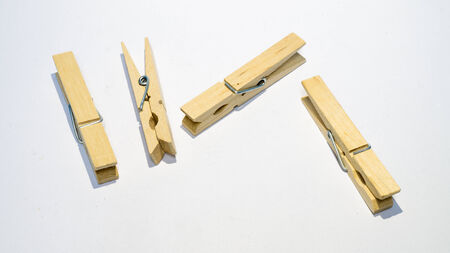 wooden clothes pin isolated on whiteの写真素材