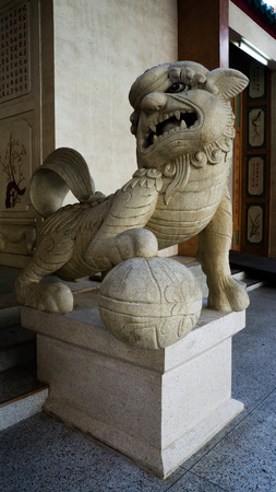 Stone lion at entrance of the Chinese temple in Thailandの写真素材