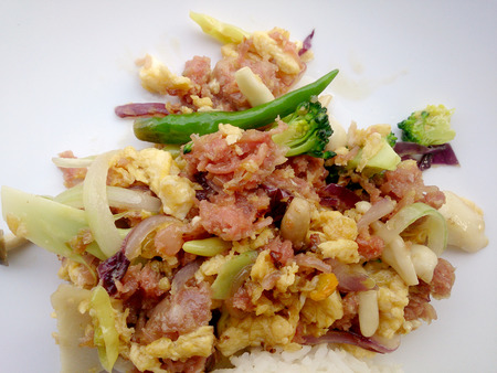 Stir-fried egg with Sour sausage in banana leaf, pork, shredded and salted, bound tighly with banana leaves & thai jasmin rice in white dishの写真素材