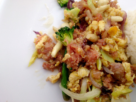 Stir-fried egg with Sour sausage in banana leaf, pork, shredded and salted, bound tighly with banana leaves & thai jasmin rice in white dishの写真素材
