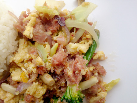 Stir-fried egg with Sour sausage in banana leaf, pork, shredded and salted, bound tighly with banana leaves & thai jasmin rice in white dishの写真素材