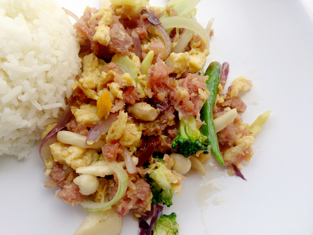 Stir-fried egg with Sour sausage in banana leaf, pork, shredded and salted, bound tighly with banana leaves & thai jasmin rice in white dishの写真素材