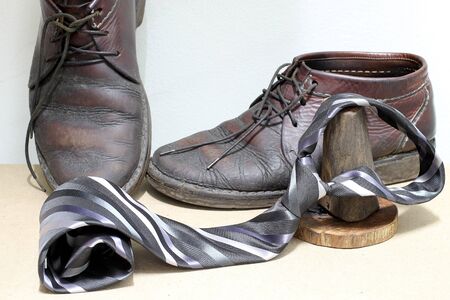 Set of fashionable man's accessories, brown boots and gray and black striped necktie on wooden background. - Happy Fathers Dayの写真素材
