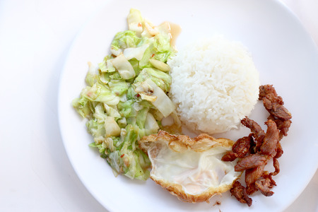 stir-fried cabbage with fish sauce, fired pork , fired egg with fish sauce  in the white plateの写真素材