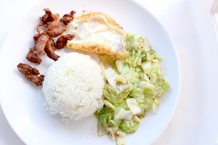 stir-fried cabbage with fish sauce, fired pork , fired egg with fish sauce  in the white plateの写真素材