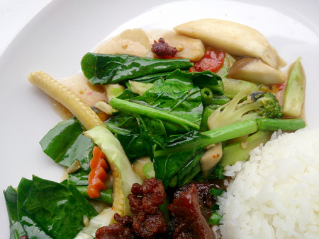 egetable stir fry and Fried pork in a plate & thai jasmine rice. Top viewの写真素材