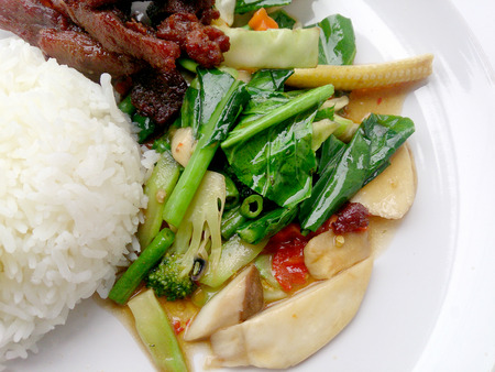 egetable stir fry and Fried pork in a plate & thai jasmine rice. Top viewの写真素材