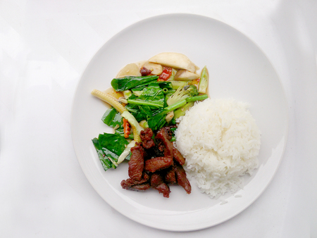 egetable stir fry and Fried pork in a plate & thai jasmine rice. Top viewの写真素材