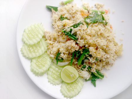 Thai fried rice with pork on white dish have lemon and Chilli fish sauce for flavourの写真素材