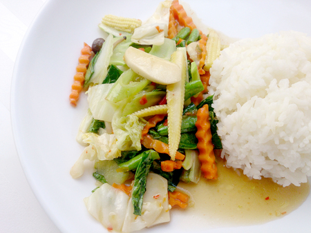 Vegetarian stir fry with thai jasmine rice on white dish, healthy foodの写真素材
