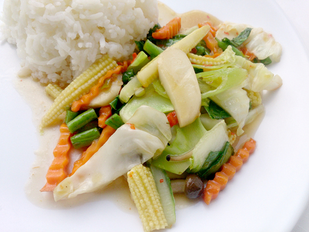 Vegetarian stir fry with thai jasmine rice on white dish, healthy foodの写真素材