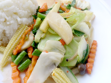 Vegetarian stir fry with thai jasmine rice on white dish, healthy foodの写真素材