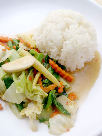 Vegetarian stir fry with thai jasmine rice on white dish, healthy foodの写真素材