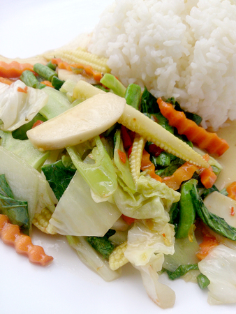 Vegetarian stir fry with thai jasmine rice on white dish, healthy foodの写真素材