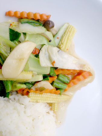 Vegetarian stir fry with thai jasmine rice on white dish, healthy foodの写真素材