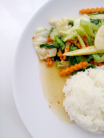 Vegetarian stir fry with thai jasmine rice on white dish, healthy foodの写真素材