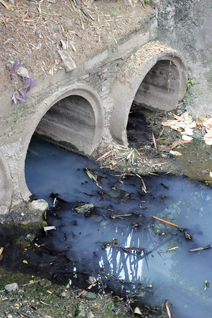 Toxic water running from sewers in dirty underground sewer for dredging drain tunnel cleaningの写真素材