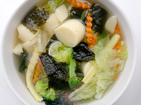 Clear Soup with Bean Curd and and mix vegetable in white bowl on white background ,Vegetarian Food, Healthy foodの写真素材