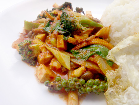 Fried vegetables and Tofu with Chilli Curry, Hot and Spicy Vegetarian Food in white dish on white background, Healthy Food. Thai Foodの写真素材