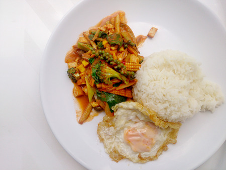 Fried vegetables and Tofu with Chilli Curry, Hot and Spicy Vegetarian Food in white dish on white background, Healthy Food. Thai Foodの写真素材