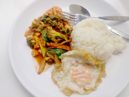 Fried vegetables and Tofu with Chilli Curry, Hot and Spicy Vegetarian Food in white dish on white background, Healthy Food. Thai Foodの写真素材