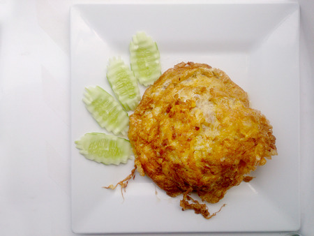 omelette on the white dish, It's popular traditional Thai style food.の写真素材