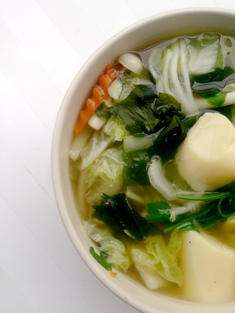 Clear Soup with Bean Curd , mix vegetable, Tofu and seaweed in white bowl on white background. Vegetarian Food, Healthy food, Thai foodの写真素材